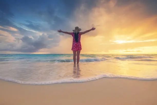 Photo of Free happy woman enjoying tropical Caribbean island beach, Dominican Republic. Summer vacation and healthy living concept.