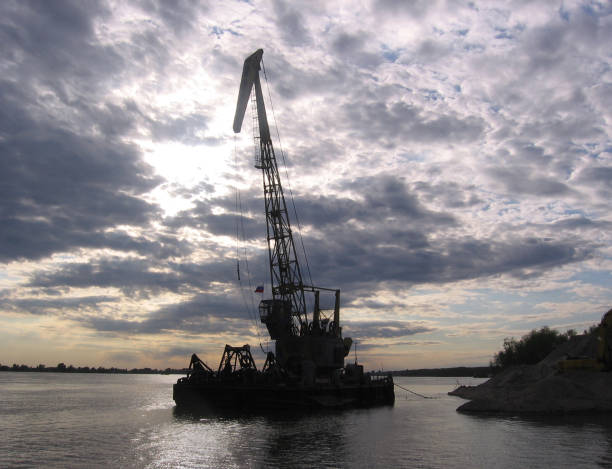 istock floating barge with crane moored to the shore on the river cargo platform 1155125271