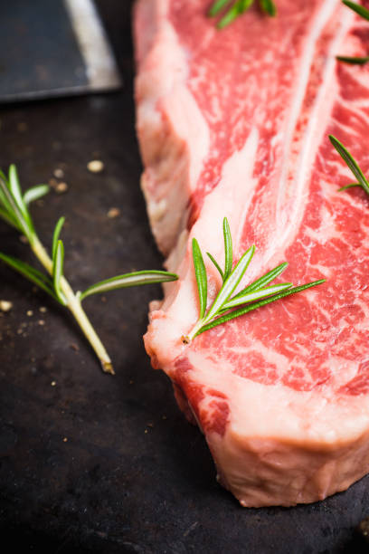 istock Raw fresh marble T-bone meat on the rustic background 1155128354