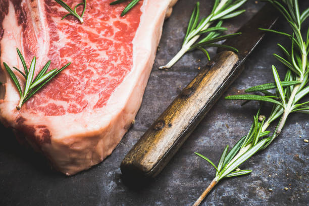 Raw fresh marble T-bone meat on the rustic background