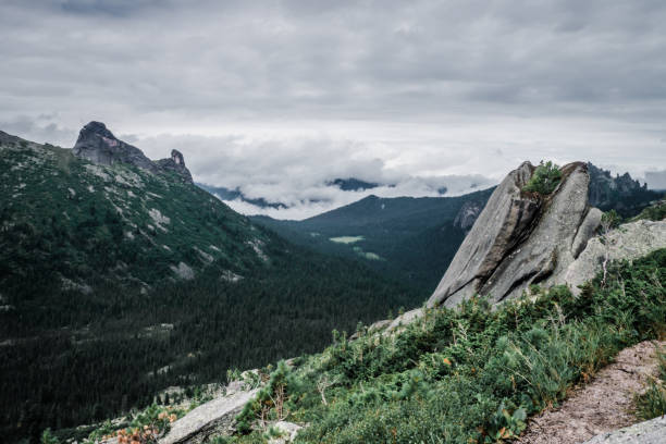 istock View of a mountain valley on a cloudy day, on top. 1155128874