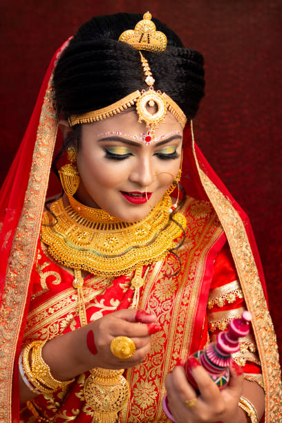 A Pretty Young Female Model Wearing Traditional Indian Bangladeshi Bridal Outfit With Heavy Gold Jewelry And Makeup Stock Photo - Download Image Now - iStock A Pretty Young Female Model Wearing Traditional Indian Bangladeshi Bridal Outfit With Heavy Gold Jewelry And Makeup Stock Photo - Download Image Now - iStock
