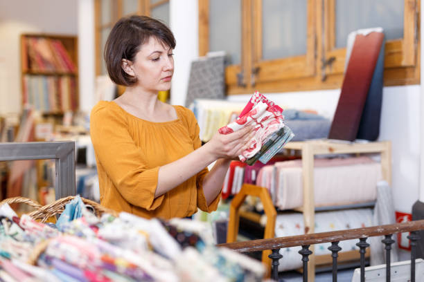 istock Woman looking for cloth in shop 1155133935