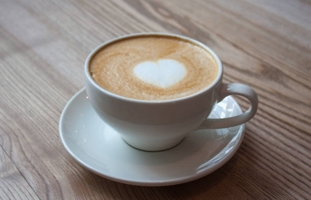 istock Cappuccino on light wooden table. 1155134619
