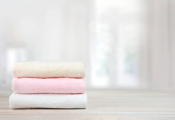 istock Stack of towels on wooden table empty space background. 1155134682