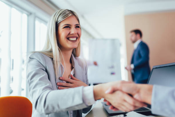 istock Business shaking hand with a client in office 1155136317