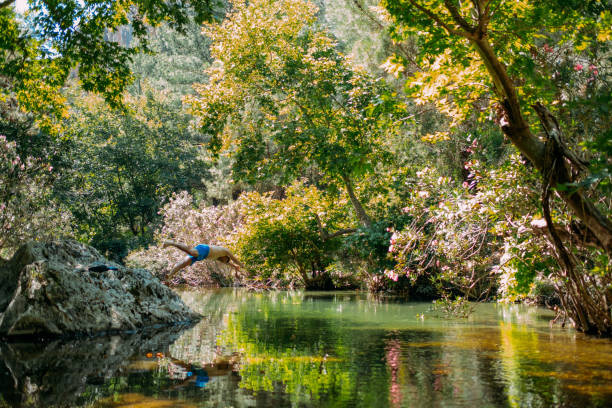 Young Man Jumping into the River