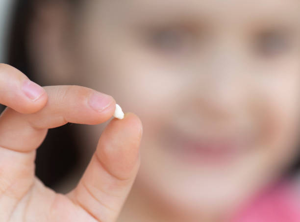 istock Girl with Milk Tooth 1155137575