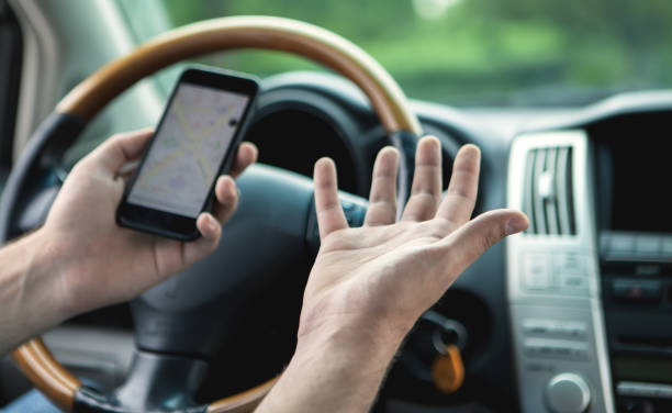 istock a young man at the wheel uses the phone as a navigator 1155138043