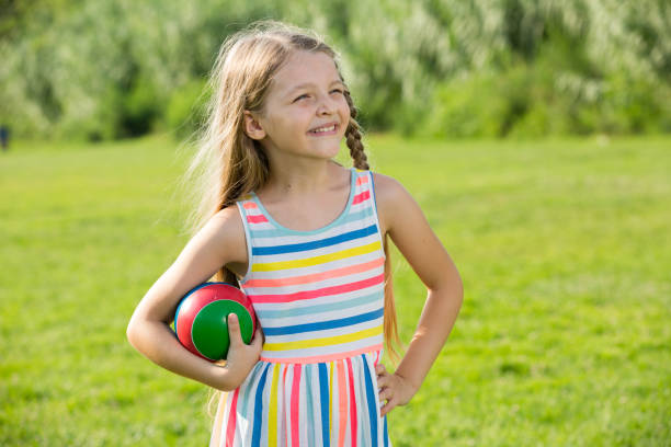 istock smiling girl with ball 1155138594