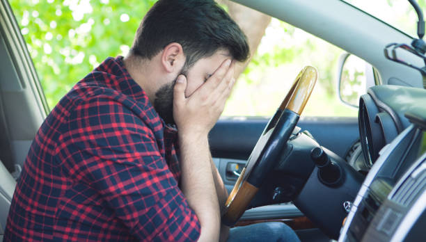 istock tired, angry, young driver covers his face by hands 1155138815