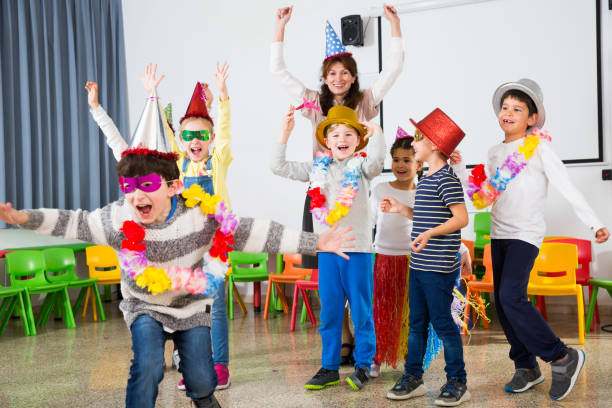 istock Pupils and teacher with festive accessories posing together 1155139673