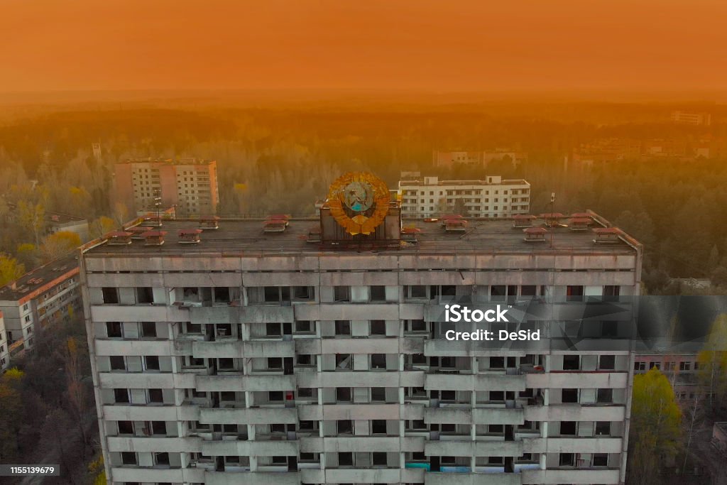 Soviet coat of arms on a building in Pripyat Soviet coat of arms on a high-rise building in Pripyat, view from above. Pripyat aerial panorama cityview over the sign of USSR on the roof of building. Pripyat City Stock Photo