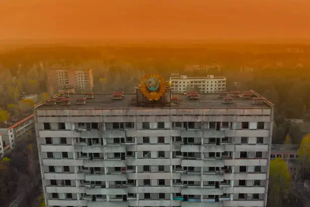 Soviet coat of arms on a high-rise building in Pripyat, view from above. Pripyat aerial panorama cityview over the sign of USSR on the roof of building.