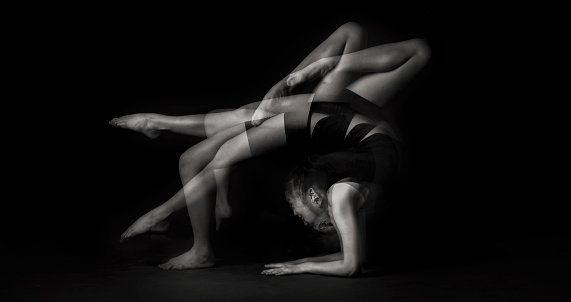 a studio shoot with multiple exposure black and white image with gymnastic posing