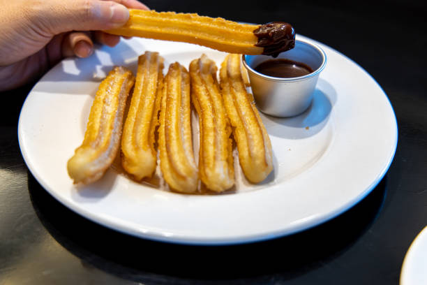 istock fried-dough pastry—predominantly choux—based snack churros with Chocolate Syrup 1155141075