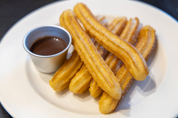 istock fried-dough pastry—predominantly choux—based snack churros with Chocolate Syrup 1155141129