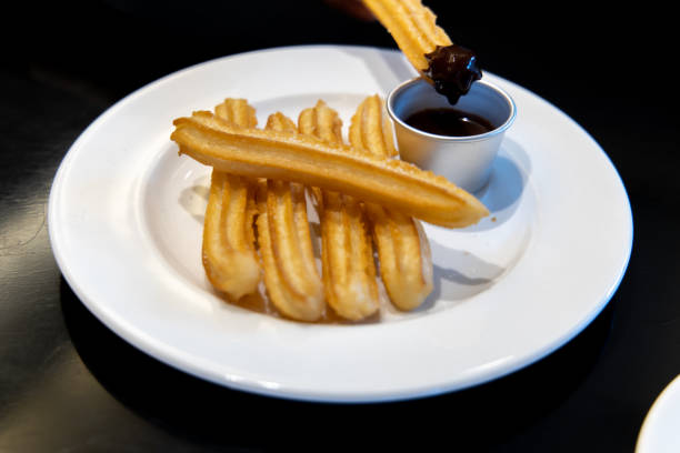 istock fried-dough pastry—predominantly choux—based snack churros with Chocolate Syrup 1155141149