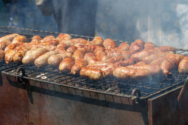 istock Sausages cooking on a grill 1155141367