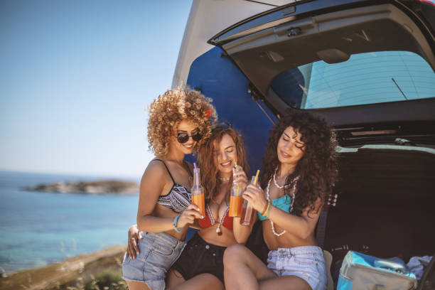istock Friends having fun in car trunk 1155142336