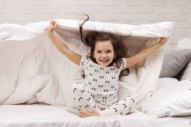 istock happy morning baby in bed. 1155142823