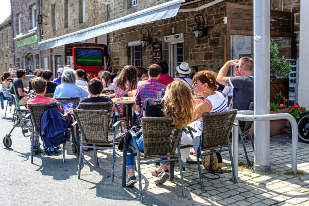 People sitting at a bar watching the football game between France and Argentina during the 2018 World Cup. The bar is located in the coastal town of Paimpol, in Bretagne, France.