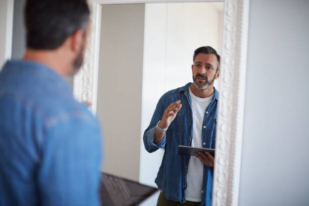 Okay you gotta do better than this Cropped shot of an attractive mature man having a rehearsal in the mirror while holding a digital tablet rehearsal photos stock pictures, royalty-free photos & images
