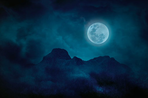 Full moon blue green with mountains and forests in the darkness, Natural scary background