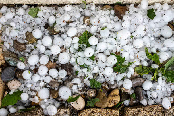 after the storm hailstones on the terrace stock photo