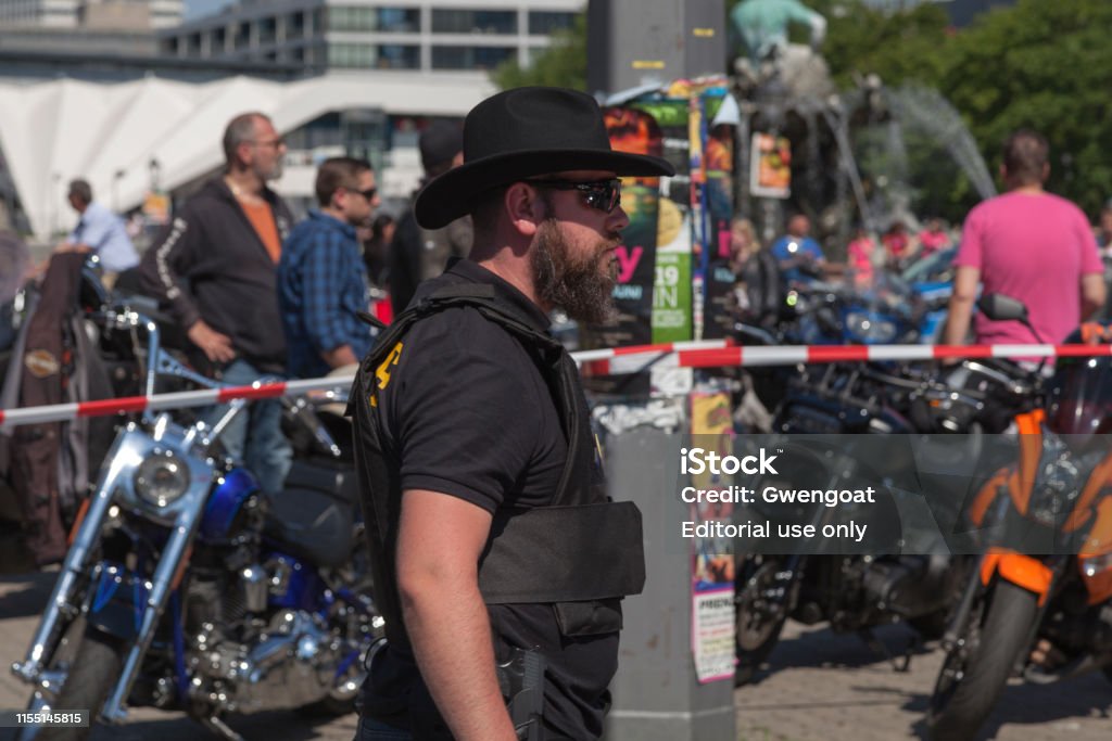 County sheriff police officer Houston, Texas - June 01 2019: A Sheriff patrolling a town square near a group of bikers. Adult Stock Photo
