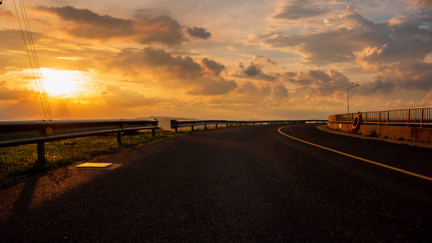 istock mountain view and road with sunset golden sky 1155146022
