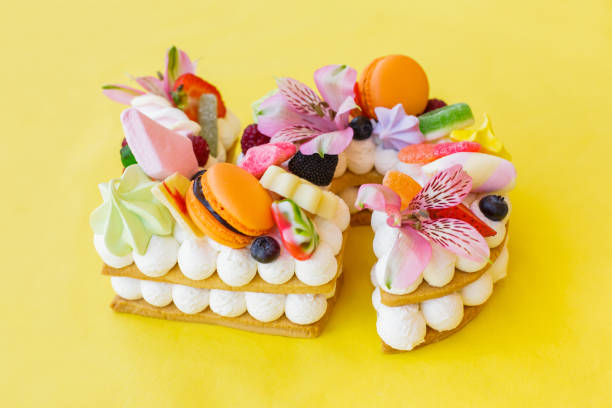 Close-up of a cake in shape of number five abundantly decorated with candies