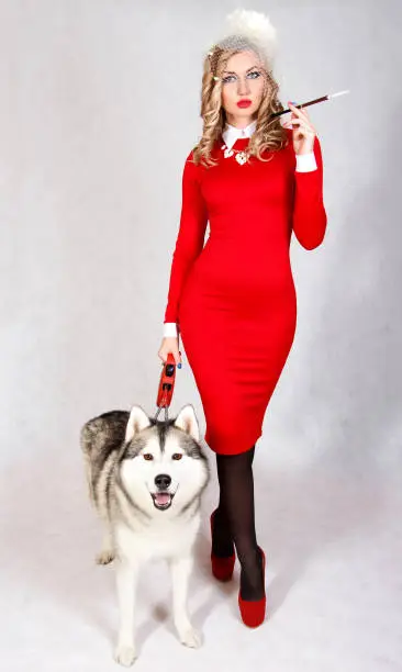 Photo of Portrait of a young attractive woman with a husky dog