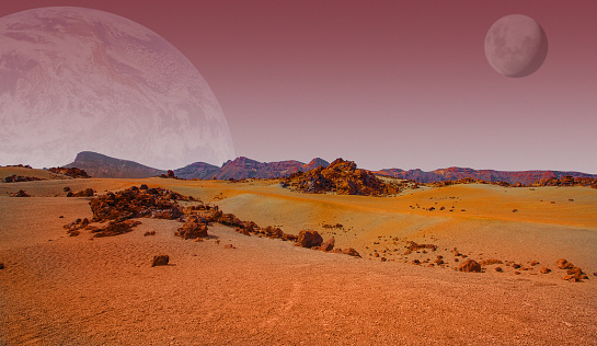 Red planet with arid landscape, rocky hills and mountains, and a giant Mars-like moon at the horizon, for space exploration and science fiction backgrounds. Elements of this image furnished by NASA.