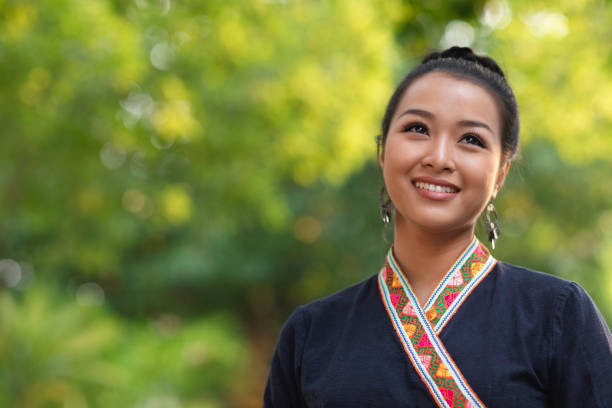 istock Young smiling woman outdoors in a park 1155149464