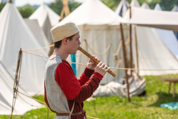 Moscow, Russia, June 8, 2019 - A young guy in medieval clothes plays the flute