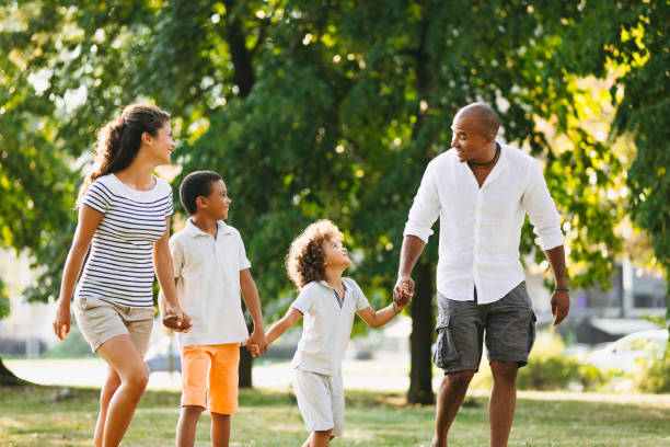 istock Happy couple spending time with their sons in the park 1155150535