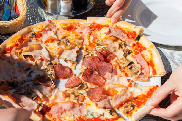 istock pizza with pepperoni, salami, pepper, cheese, close-up. 1155151972