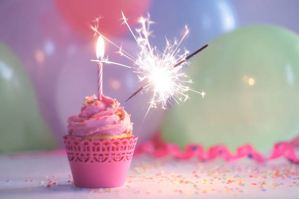 istock Birthday cupcake with candle and sparkler 1155155130