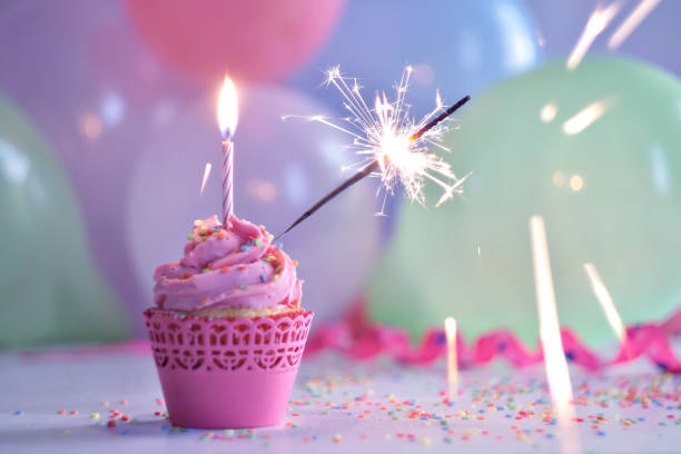 istock Birthday cupcake with candle and sparkler 1155155141
