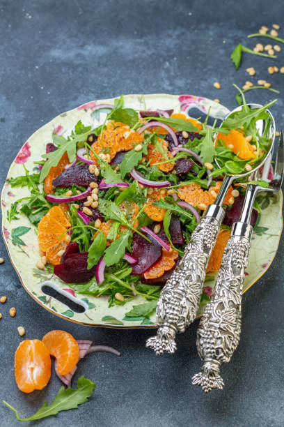 istock Organic arugula salad, tangerine and baked beetroot. 1155155231