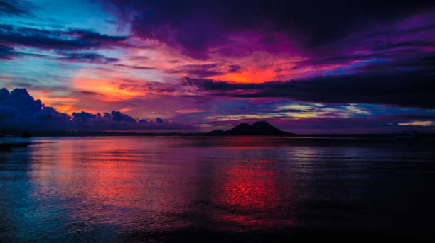 Rapopo Sunset. Sunset at Rapopo Resort Hotel looking towards the Simpson Harbour and Rabaul Volcanoes. new britain island stock pictures, royalty-free photos & images