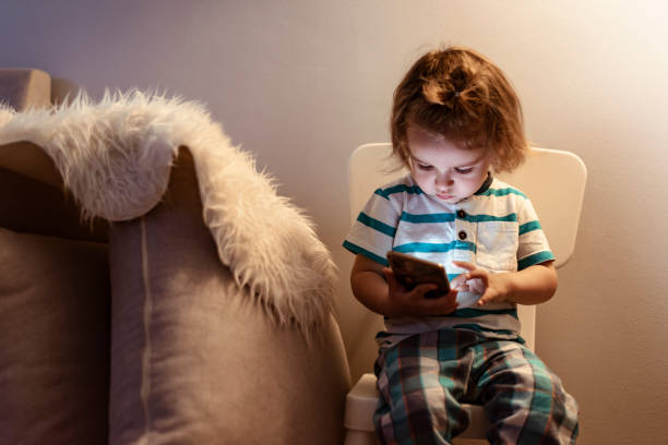 istock Baby boy Having fun with his phone 1155157406