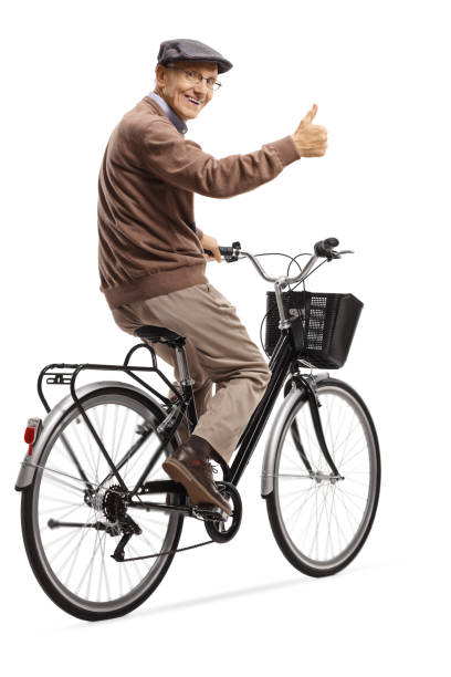 istock Cheerful elderly man on a bicycle giving thumbs up 1155158132