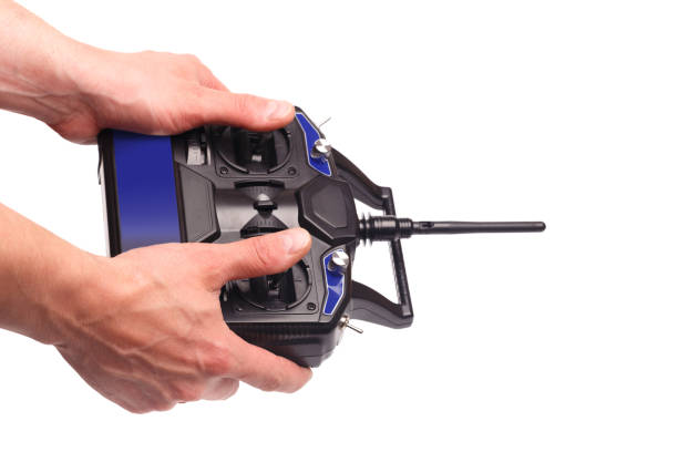 istock mans hands holding remote control with joysticks and antenna  isolated on white background - image 1155161386