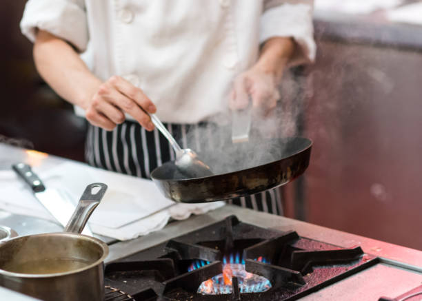 istock Chef cooking food in the kitchen, Chef preparing food 1155163817