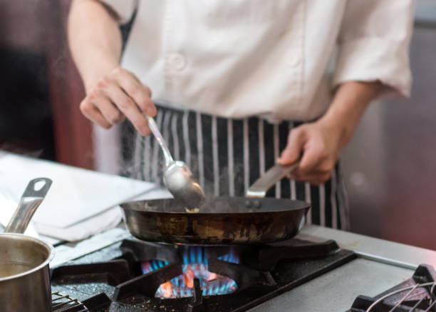 istock Chef cooking food in the kitchen, Chef preparing food 1155163824