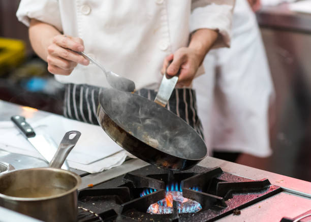 istock Chef cooking food in the kitchen, Chef preparing food 1155163828