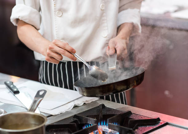 istock Chef cooking food in the kitchen, Chef preparing food 1155163831