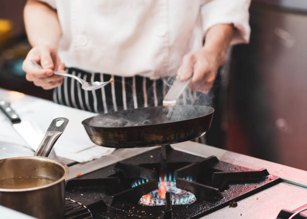 istock Chef cooking food in the kitchen, Chef preparing food 1155163832